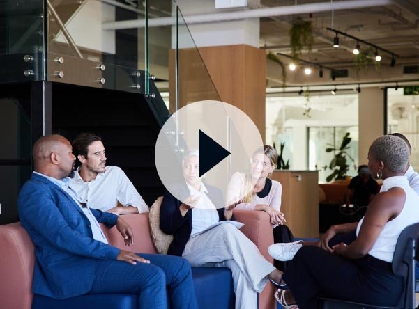 Group of business people sitting together talking